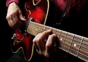 Guitarist hands and guitar close up